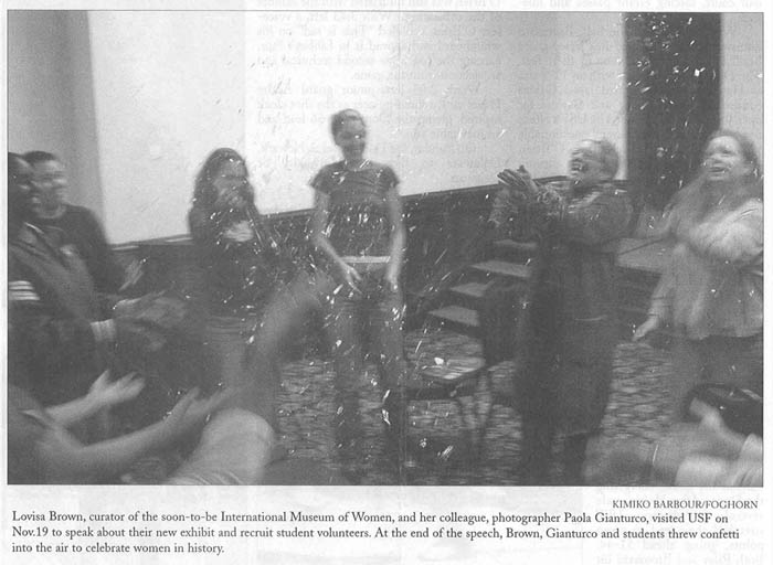 Photograph of students with Paola Gianturco throwing confetti to celebrate women